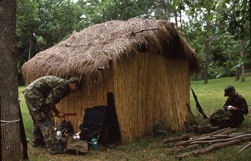 Survival school students near a hut, Liberal, 1982