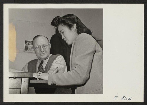 Attorney Ulys A. Lovell, and his resident secretary, Miss Fujiye Jitsumyo. Along with his duties as legal adviser to the center appointed staff, the project attorney also carries on a legal aid for center residents, (former west coast persons of Japanese ancestry). Photographer: Parker, Tom Denson, Arkansas