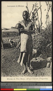 Woman with musical instrument, Tanzania, ca.1920-1940