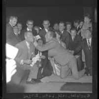 Kirk Douglas smearing cement on Ken Murray's face at Grauman's Chinese Theater, 1962