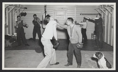 [detainees boxing and lifting weights]