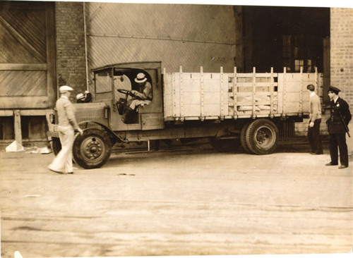 [Police officer and delivery truck during Longshoremen's Strike]