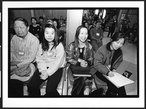 Four people of Chinese origin listening to lecture at Cameron House, Chinatown, San Francisco, California, 2002