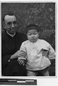 Fr. Cummings with an orphan at Luoding, China, 1935