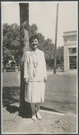 [Young woman posed on street]