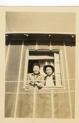 Men posing out window