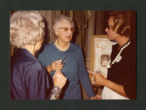 Dorothy Drake converses with two colleagues at Denison Library's 50th birthday party, Scripps College