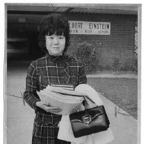 Barbara Matsui, a teacher at Sacramento High School, carries books, papers and her purse