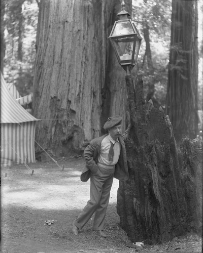Man leaning on lamp post, Bohemian Grove. [negative]