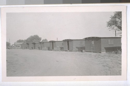 July, 1936, Kern County, Kern Lake District. Typical laborer shanties. Note the screen doors are off several of the cabins