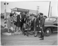 Chamber of Commerce ladies chastising Dick Russell for speeding ticket, Los Angeles, 1947