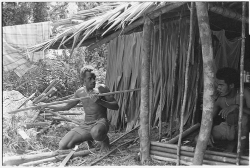 Ubuni, left, and Sale 'Oirukua, right, work on new house, Kwailala'e