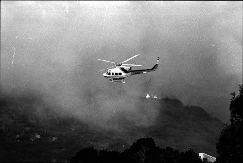 Helicopter in smoky sky