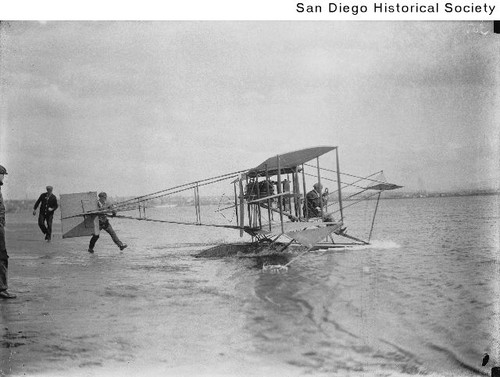 Glenn Curtiss at the controls of his seaplane at a beach on North Island