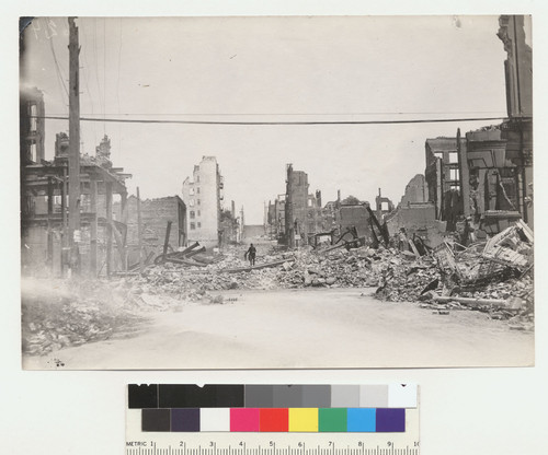 [View of ruins and rubble along unidentified street.]