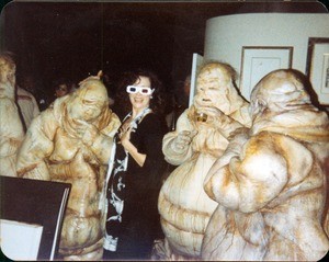 A woman in the middle of people in blob-like costumes