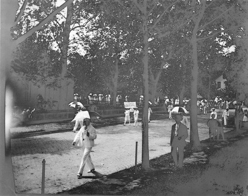 Parade of men carrying umbreallas, Pasadena