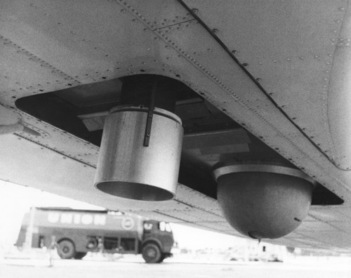 In 1962 Applied Oceanography Group (AOG) at Scripps Institution of Oceanography leased this DC-3 airplane and it would later be given to them for continued research. This photo shows the infrared radiometer mounted to the bottom of the plane to measure heat flow from the ocean. With the airplane it was possible to survey 10,000 square miles of sea surface in 24 hours. Circa 1965