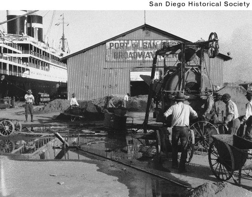 Men using construction equipment at the Broadway Pier