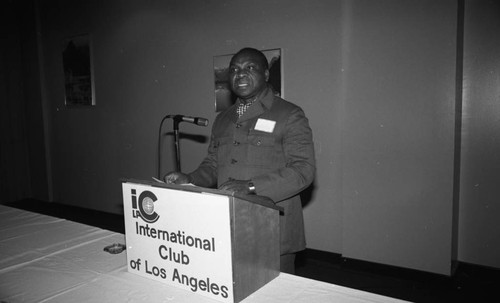 Man speaking from a lectern at an International Club of Los Angeles event, Los Angeles, 1981