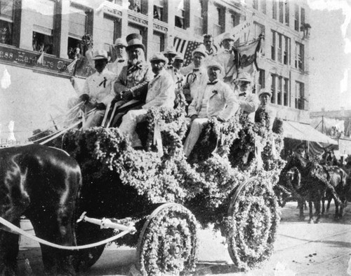 Men in decorated carriage, San Pedro