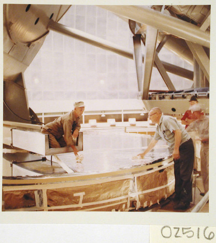 Workmen washing the 200-inch telescope mirror on the flor of the dome, Palomar Observatory