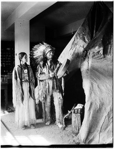 Display of a Native American couple wearing traditional dress at the Pacific Southwest Museum