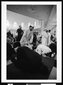 Men bowing in prayer, Los Angeles, 1999
