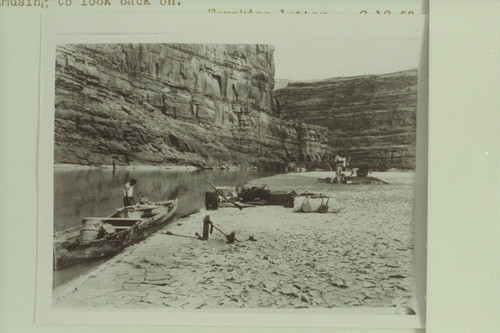 Camp on the Colorado River between Moab and the mouth of the Green River. Two motor boats running tandem and the 10-ft. Fold-Flat boat of Nevills borrowing on the shore