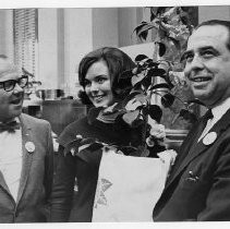 Camellia Queen Joan Martin presents flowers to Sacramento Assemblymen Walter W. Powers (left) and Edwin L. Z'berg