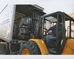 Big Dennis Henderson drives a forklift and loads boxes into a truck, Sunset Line & Twine Company in Petaluma, California, Dec. 2006