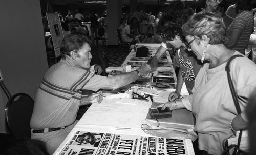 Chuck Connors greeting fans at a baseball event, Los Angeles, 1985