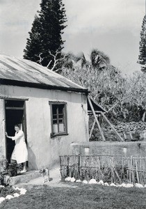 A missionary nurse, Miss Bieli, in front of the health center of Netche
