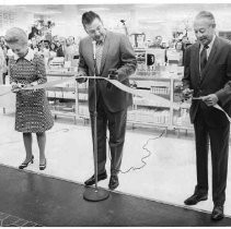Unidentified woman and two unidentified men conducting ribbon-cutting ceremony at J. C. Penney store
