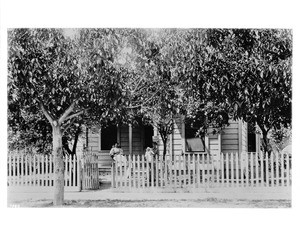 Portrait of a family in front of their home on Ninth Street between Spring Street and Broadway, Los Angeles, ca.1890-1900