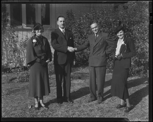 Two men and two women, men shaking hands, [1930s?]