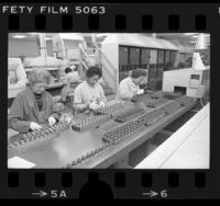 Three women working on semiconductor assemblies at International Rectifier Corp. in Los Angeles, Calif., 1977