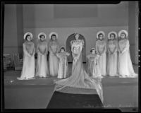 Women and girls dressed as bridal party at fashion show, 1935