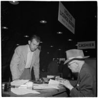 George Roberts fills out paperwork to purchase the first truck sold at the War Assets Administration's surplus sale, Port Hueneme, May 1946