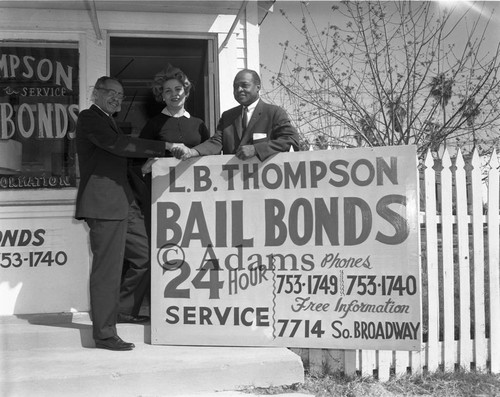 Loren Miller standing with Mr. L. B Thompson and Mrs. Maxine Thompson in front of their office, Los Angeles, 1963