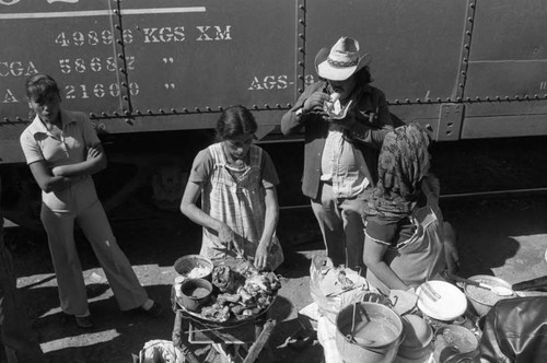 Women sell food at a train stop, Chihuaha, 1983