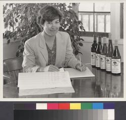 Katie Wetzel Murphy, seated with computer printout and wine bottles at Alexander Valley Vineyards in Alexander Valley, California