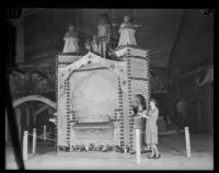 Woman stands next to a display at the National Orange Show, San Bernardino, 1926