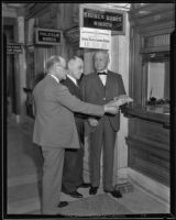 Postmaster Henry B. R. Briggs with two other men at a post office, Los Angeles, 1934-1926