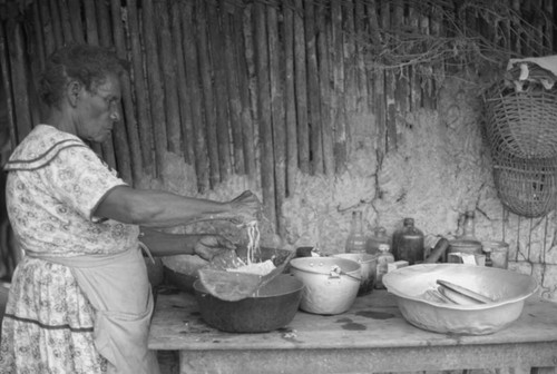 A woman works in the kitchen with grated coco, San Basilio de Palenque, 1976