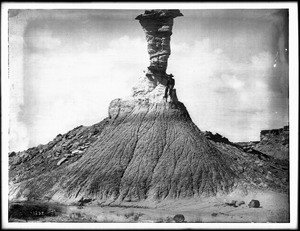 Man sitting near the top of Eagle Head (rock formation) in the petrified forest of Arizona, ca.1900