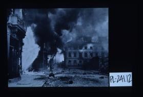 Poster depicting burning buildings in Warsaw