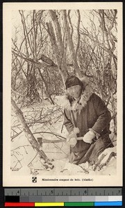 Missionary father cutting wood in a forest, Alaska, ca.1920-1940