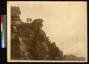 Two Chinese men walking along a rocky ledge, Kuling, Jiangxi, China, ca.1900-1932