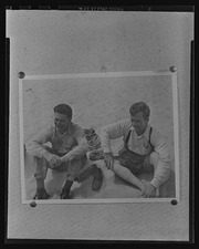 Thumbtacked photograph of Dave Hedley and man on beach, California Labor School